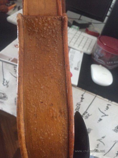 在琴箱的下部侧板面上喷少量脱漆剂，起了非常多的小泡泡